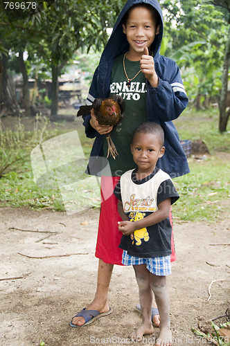 Image of editorial happy boy with pet hen chicken corn island nicaragua