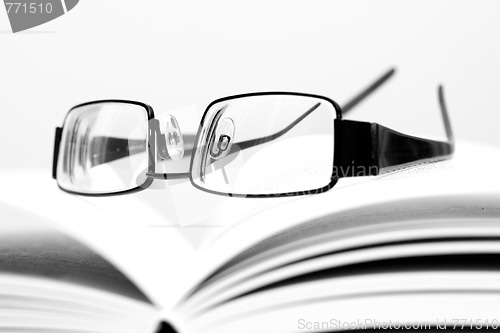 Image of Eyeglasses on open book