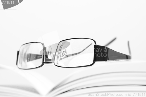 Image of Eyeglasses on open book