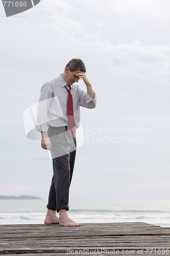 Image of Worried businessman at the sea