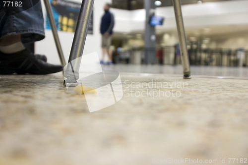 Image of Floor view with a dropped snack at an airport