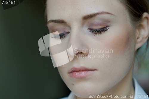Image of Woman applying makeup