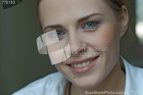 Image of Woman applying makeup