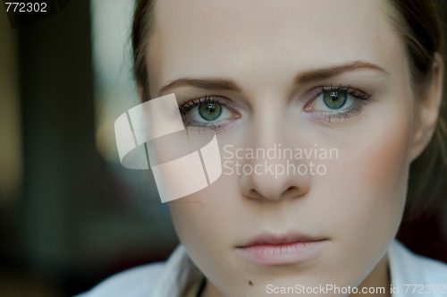 Image of Woman applying makeup
