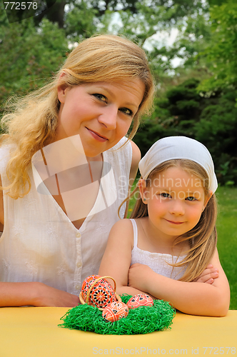 Image of Young mother and daughter having Easter time
