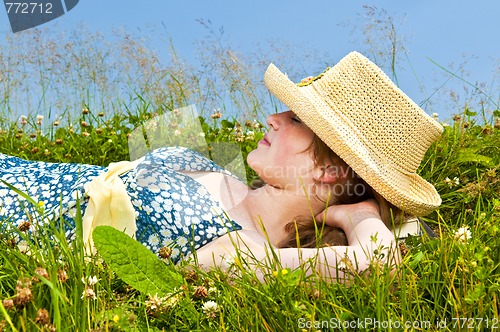 Image of Young girl resting in meadow