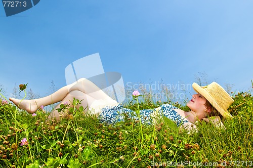 Image of Young girl laying in meadow