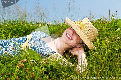 Image of Young girl laying on meadow