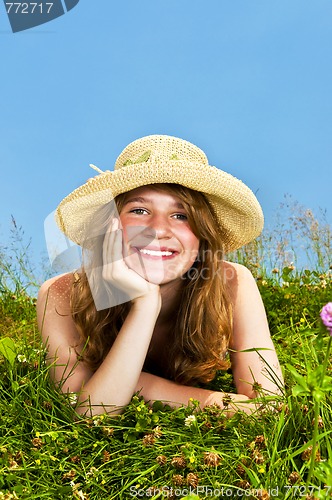 Image of Young girl laying in meadow