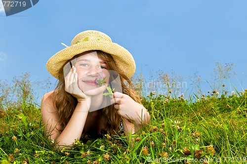 Image of Young girl laying in meadow