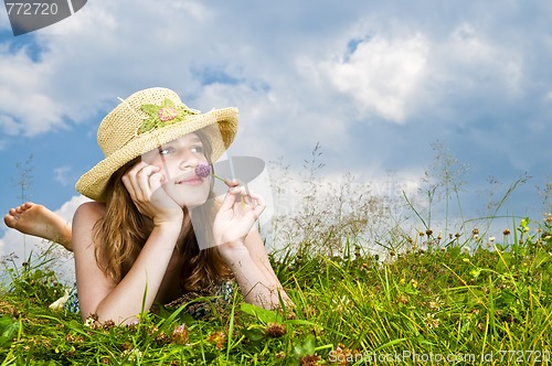 Image of Young girl laying in meadow