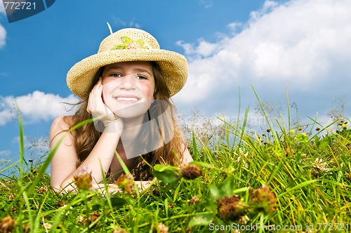 Image of Young girl laying in meadow