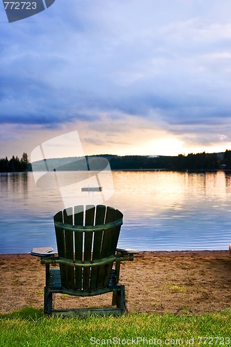 Image of Wooden chair at sunset on beach