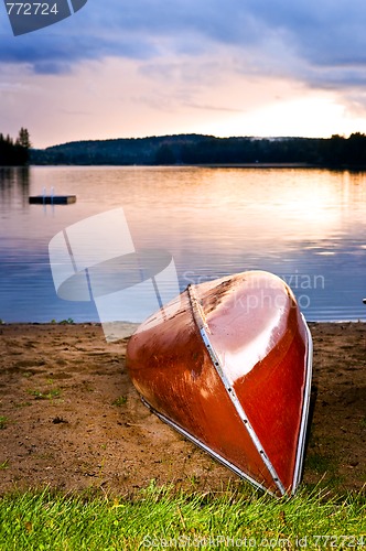 Image of Lake sunset with canoe on beach