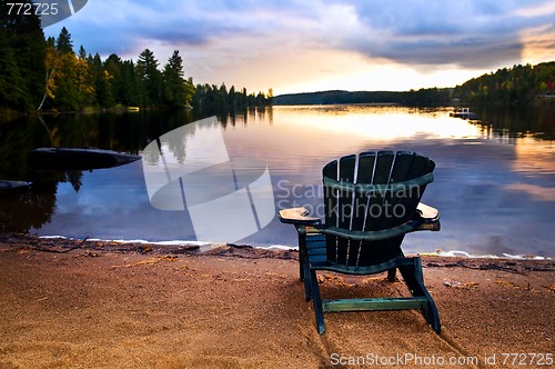 Image of Wooden chair at sunset on beach