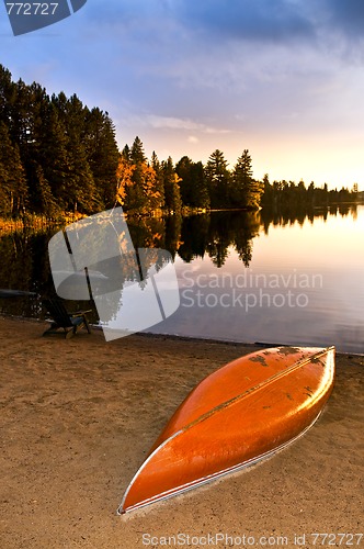 Image of Lake sunset with canoe on beach