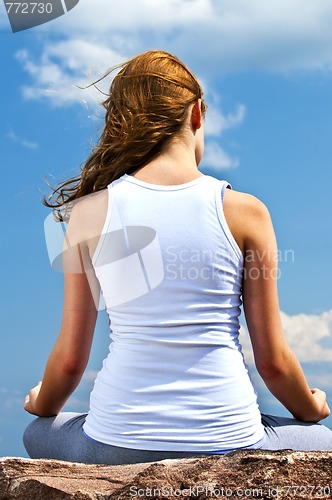 Image of Young girl meditating outdoors