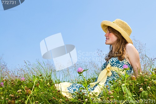 Image of Young girl sitting in meadow