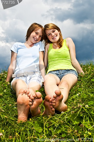 Image of Young girls sitting in meadow
