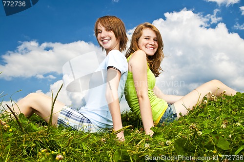Image of Young girls sitting in meadow