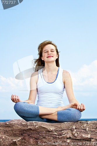 Image of Young girl meditating outdoors