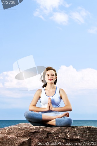 Image of Young girl meditating outdoors