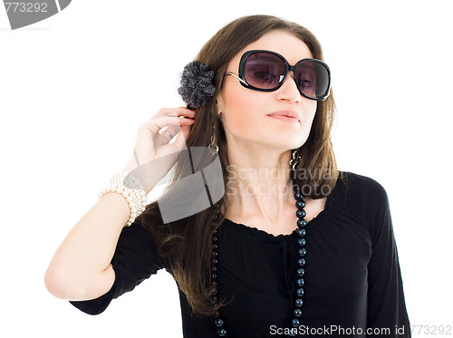 Image of Woman in black dress and sunglasses listen