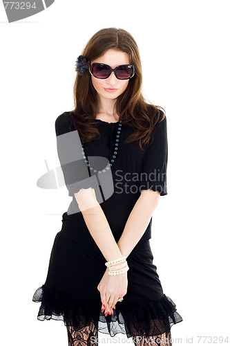 Image of Woman in black dress and sunglasses