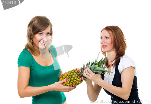 Image of Two woman pull pineapple