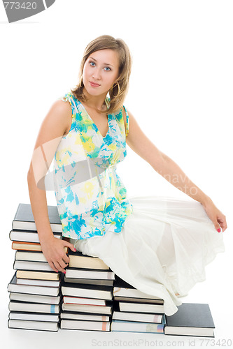 Image of woman sitting on books