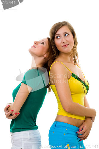 Image of Two women friends standiing together back to back