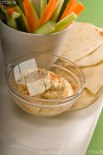 Image of hummus dip with pita bread and vegetable