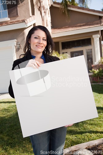 Image of Attractive Hispanic Woman Holding Blank Sign in Front of House
