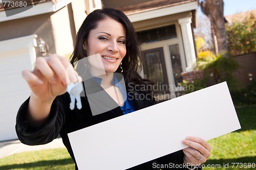 Image of Attractive Hispanic Woman Holding Blank Sign in Front of House