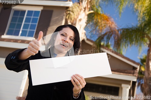 Image of Attractive Hispanic Woman Holding Blank Sign in Front of House