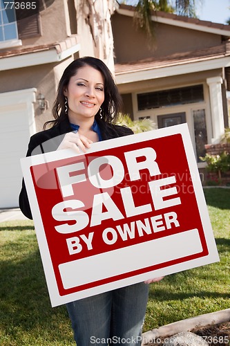 Image of Hispanic Woman Holding For Sale By Owner Real Estate Sign In Fro