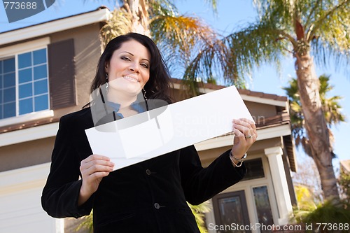 Image of Attractive Hispanic Woman Holding Blank Sign in Front of House