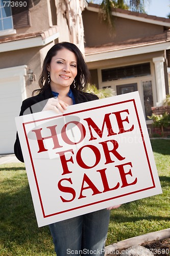 Image of Woman Holding Home For Sale Real Estate Sign In Front of House