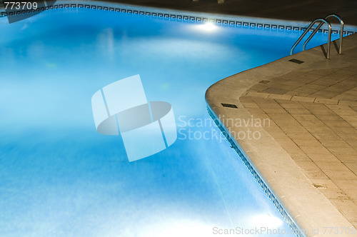Image of hotel large swimming pool with night lights