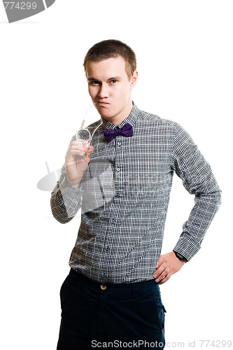 Image of Embarrassed young man holding glasses