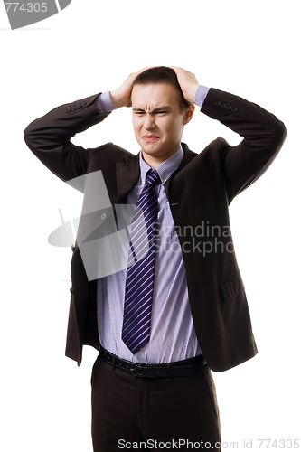 Image of Very upset young man holding head with hands wearing formal suit