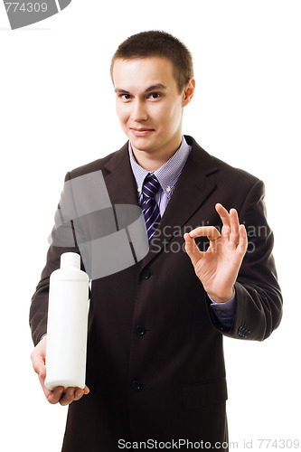 Image of Young businessman advertise new product holding blank bottle