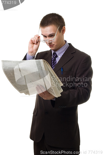 Image of Young hansome man in suit with newspaper