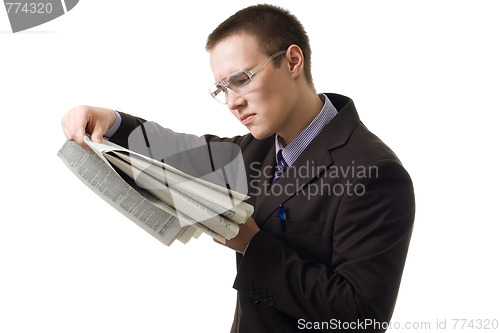 Image of Young hansome man in suit read newspaper