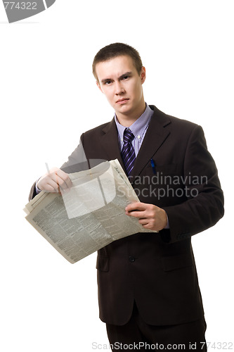 Image of Young man reading newspaper standing 