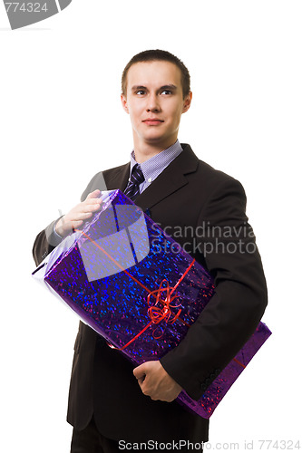 Image of Young handsome man with one huge blue gift