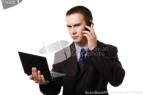 Image of Young handsome man with cell phone and laptop