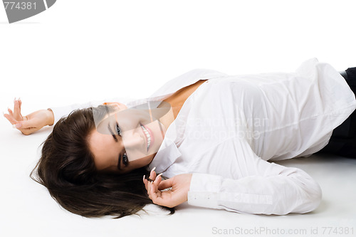 Image of Young happy woman in white lay on the floor