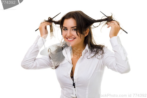 Image of woman twirl her hair with sticks