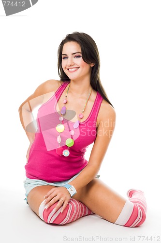 Image of Woman in pink with big smile sit on the floor